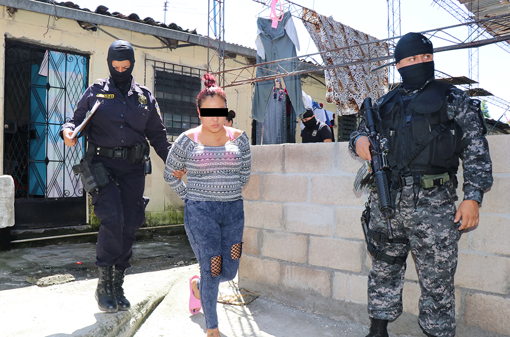 Police in El Salvador arrest a woman for human trafficking.